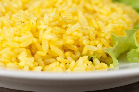 golden rice with lettuce at plate closeupの写真素材