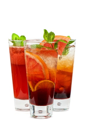 Set of fresh cold tea with fruits, berries and ice on whiteの写真素材