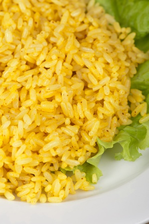 golden rice with lettuce at plate closeupの写真素材