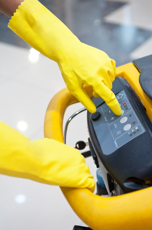 Cleaner workers with mop in uniform cleaning floorの写真素材