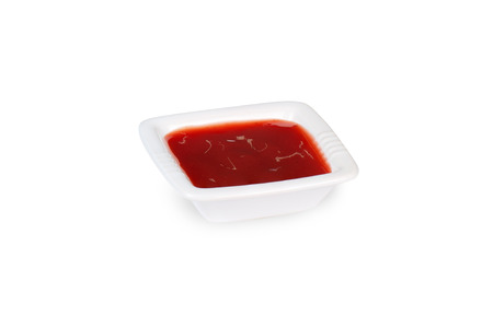 Bowl of ketchup isolated on whiteの写真素材