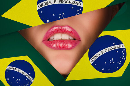 Beautiful female lips closeup behind brazil backgroundの写真素材