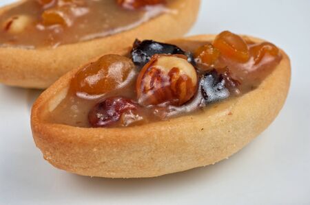 French basket sweet cakes with chocolate and nuts closeup photo