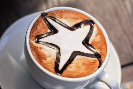 Cup of coffee with star shape closeup shot from aboveの写真素材