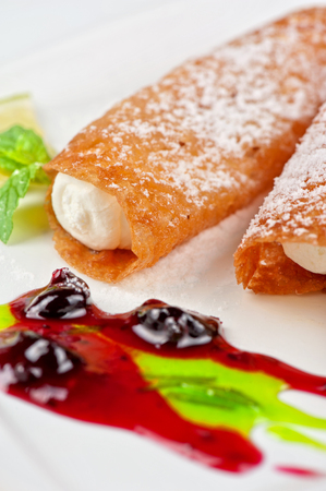 Sicilian cannoli at plate decorated with lime and jamの写真素材