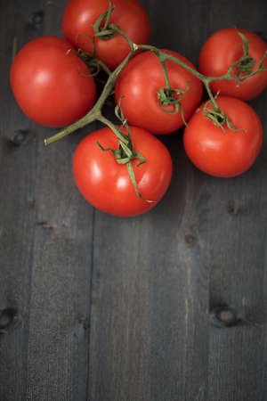 Fresh tomatoes on vintage wooden tableの写真素材