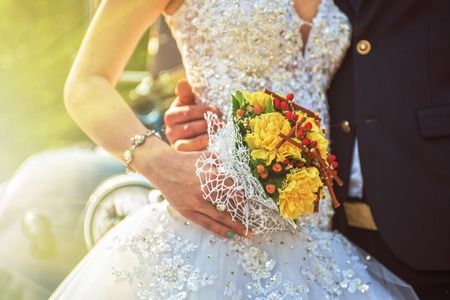 Beautiful wedding bouquet in hands of the brideの写真素材