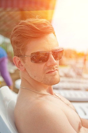 Man at the summer beach, closeup portraitの写真素材