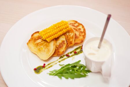 corn pancakes with cream at plateの写真素材