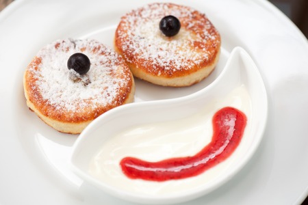 cottage cheese pancakes with strawberry sauce and sour creamの写真素材