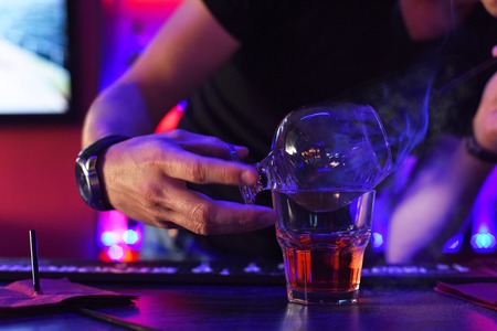 Closeup photo in a bar where barmen makes cocktail