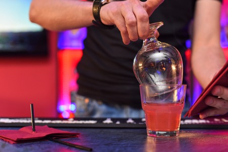 Closeup photo in a bar where barmen makes cocktailの写真素材
