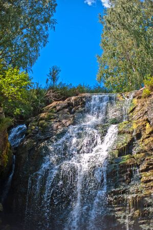 Waterfall in summer siberian forest