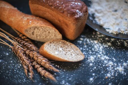 Bread composition with wheats. Very shallow DOF photo and specific art curly bokeh for extra volume.の写真素材