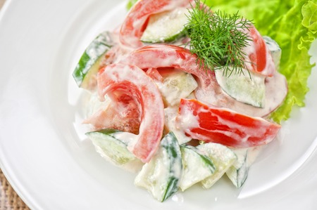 Salad from cucumber tomato and sour creamの写真素材