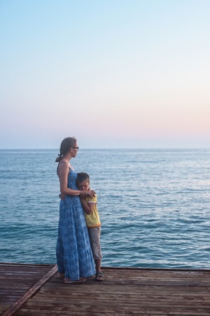mother and son on the pier in the evening at Alania, Turkeyの写真素材