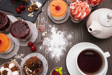 Table with cakes ans tea itemsの写真素材