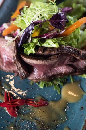 beef meat salad with herbs vegetables and sauce