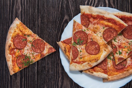 Pepperoni pizza on wooden table