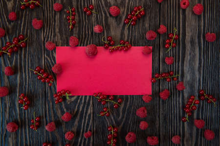 Fresh berries raspberry and red currant on wooden table, background for designの写真素材