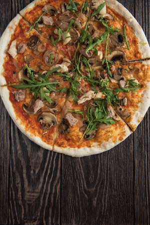 Pizza with chicken mushrooms and rukkolaの写真素材
