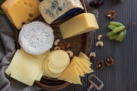 Various types of cheese set with grapes and nutsの写真素材