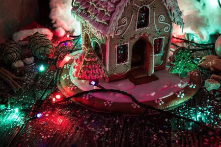 Gingerbread house with lights on dark background, xmas themeの写真素材