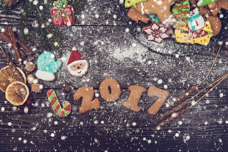 Gingerbreads for new years and christmas on wooden background, xmas theme