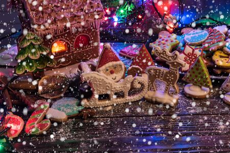 Gingerbreads for new years and christmas on wooden background, xmas themeの写真素材