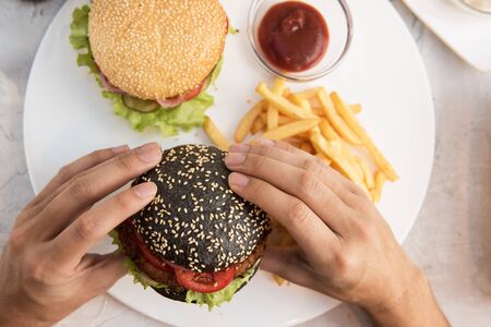 Man eating burgers