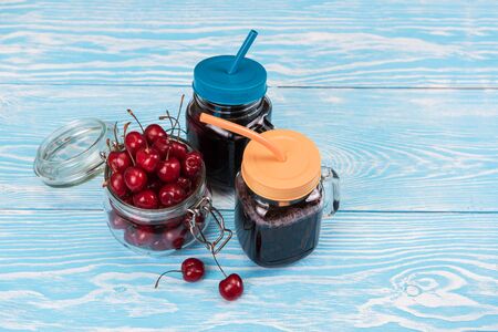 Cherry juice with glass of berriesの写真素材