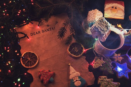 Letter for Santa on decorated chrismas background with gingerbread coocies and garlandの写真素材