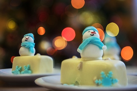 Christmas dessert with snowman on lights bokeh backgroundの写真素材