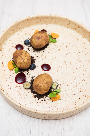 Delicious creative cakes made in the form of real raw potatoesの写真素材