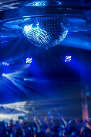 Disco ball with bright rays, night party or concert backgroundの写真素材