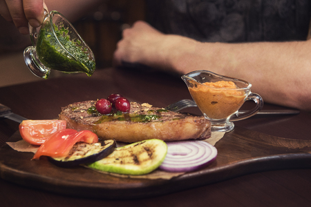grilled beef steak with sauce and vegetablesの写真素材