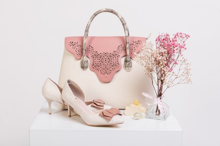 Female handbag, shoes and bouquet of dried flowers on white backgroundの写真素材
