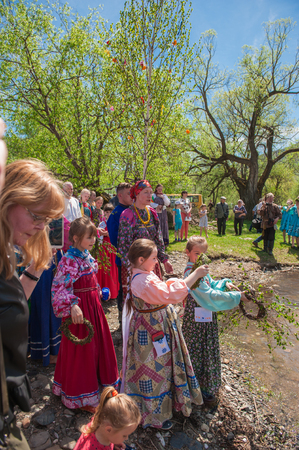 TOPOLNOE, ALTAY, RUSSIA - May 27, 2018: Folk festivities dedicated to the feast of the Holy Trinity. Ancient Russian rite: sinking a birch.のeditorial素材