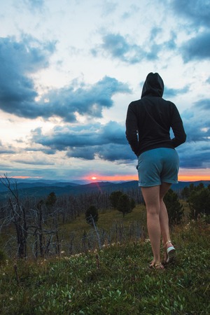 Travel, lesure and freedom concept - woman on the top of Altai mountain, beauty summer evening...