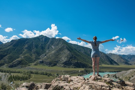 Woman taking selfie on mobile phone with stick. Vacation in the mountainの写真素材