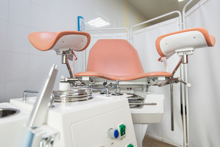 Gynecological cabinet with chair and other medical equipment in modern clinicの写真素材