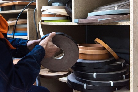 Furniture production concept: man working at furniture factoryの写真素材