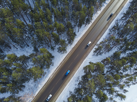 Aerial view of a road with traffic in winter landscape