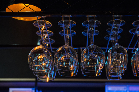 Empty clean glasses for wine above a bar rack