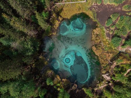 Beautiful Geyser (blue, silver) lake with thermal springs that periodically throw blue clay and silt...