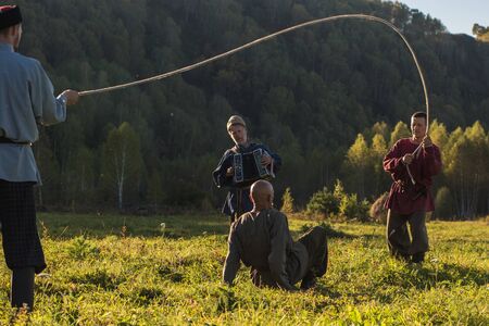 CHARISHSKOE. ALTAISKIY KRAI. WESTERN SIBERIA. RUSSIA - SEPTEMBER 15, 2016: descendants of the Cossacks in the Altai, cossacks play in ancient Slavic national game: rope jumping at the festival on September 15, 2016 in Altayskiy krai, Siberia, Russia.のeditorial素材