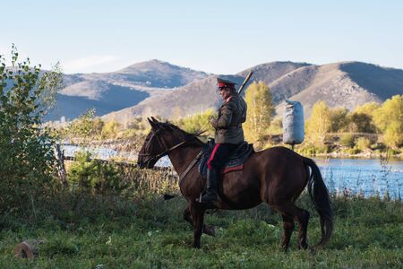 CHARISHSKOE. ALTAISKIY KRAI. WESTERN SIBERIA. RUSSIA - SEPTEMBER 15, 2016: descendants of the Cossacks in the Altai, cossack rides a horse, with a saber at the festival on September 15, 2016 in Altayskiy krai, Siberia, Russia.のeditorial素材