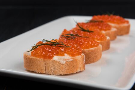 Sandwich with caviar and butter on a white plate.の写真素材