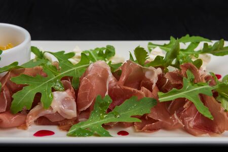 Famous Italian food Prosciutto with arugula closeup photoの写真素材
