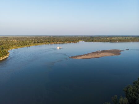 Aerial view of big siberian Ob river and ship, summer day, drone shotの写真素材